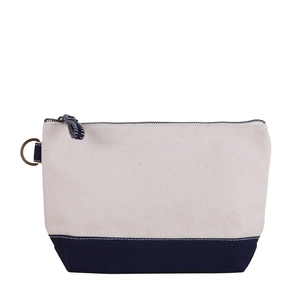 Beige and navy pouch with a zipper on a wooden surface and light gray background